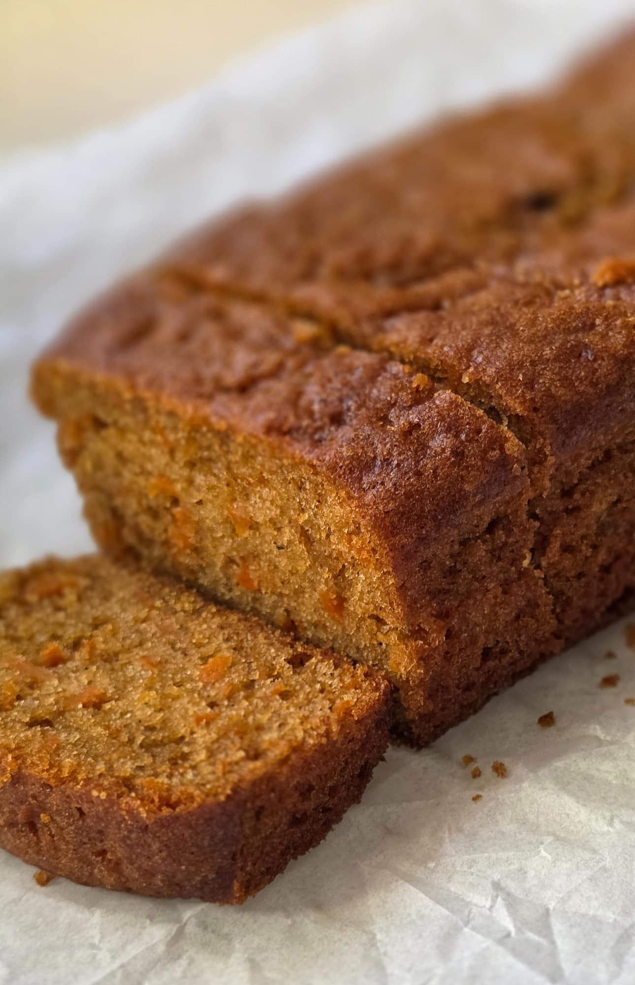 Freshly baked carrot loaf cake, sliced to show its tender crumb
