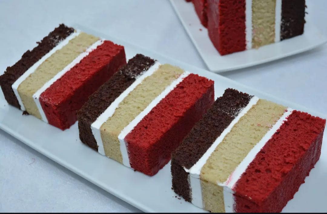 Neatly portioned layered cake slices: chocolate, vanilla and red velvet